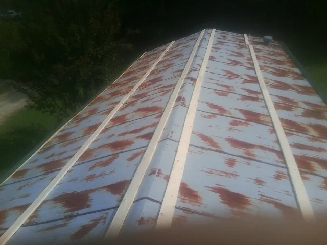 Rusted metal roof panels with new wood purlins before replacement — Storm Damage Roof Repair in Niagara by Roofing Brothers